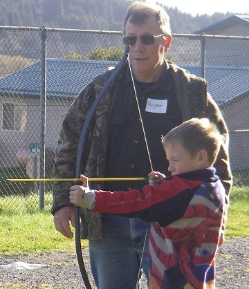 Roger Smith teaches archery to the After School Program